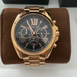 Michael Kors boyfriend style rose gold watch with black face.